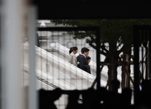 Paetongtarn Shinawatra, the ousted Thai prime minister, walking down stairs with aides