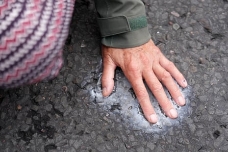 The hand of a protester superglued to the road.