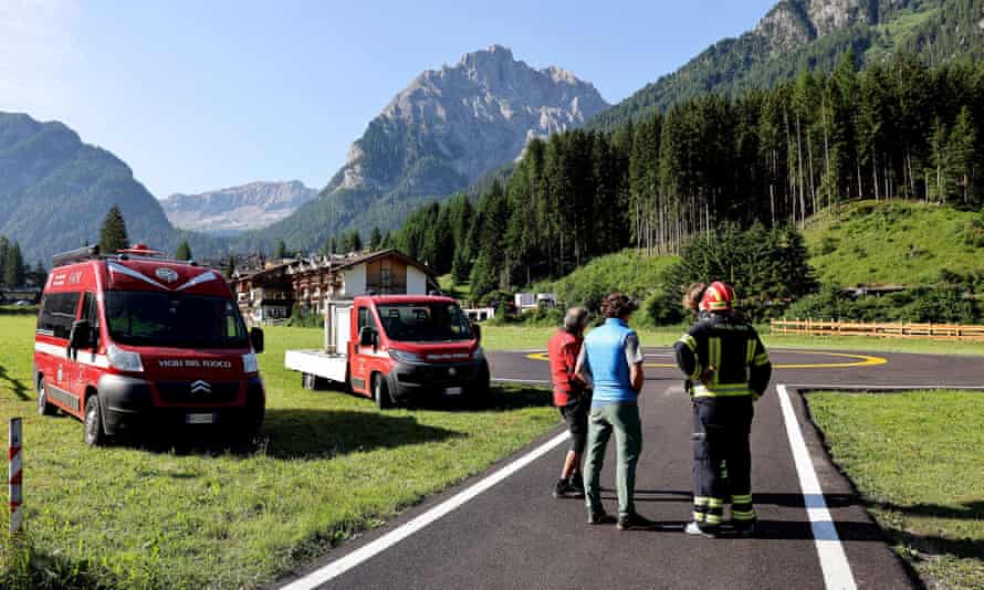 Rescue teams gather at the bottom of the Marmolada mountain in the aftermath of the avalanche