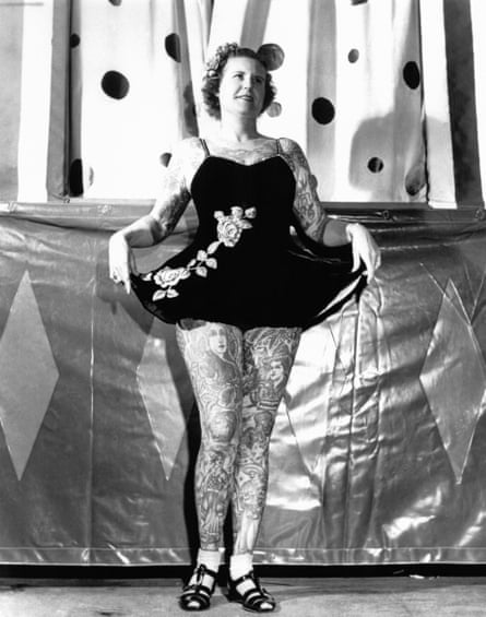 Betty Broadbent on stage, showing her tattoos