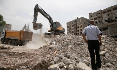 An excavator removes the remains of heavily damaged and destroyed buildings from February's powerful quake in Kahramanmaras, south-eastern Turkey.