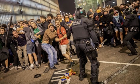 Spanish police clash with protesters during a demonstration at El Prat airport, on the outskirts of Barcelona on Monday.
