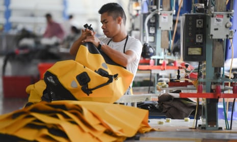 A worker processes outdoor waterproof bags for the domestic market at the workshop of the Wellgreen Outdoor Co., Ltd. in Fuzhou, southeast China's Fujian Province, Nov. 2020. Photo by Xinhua/REX/Shutterstock (11010364b)