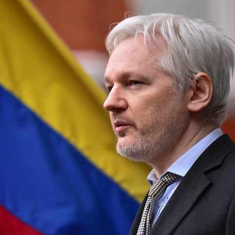 Julian Assange in front of an Ecuadorian flag