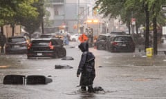 a person walks across a flooded street