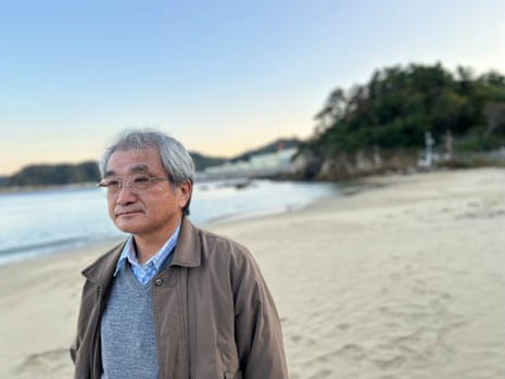 Tsuyoshi Suda an anti-nuclear campaigner with Onagawa nuclear power plant in the background