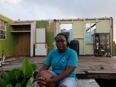 Knacynthar Nedd, leader of the Barbuda council, sits on the doorstep of a house that lost two walls and its roof