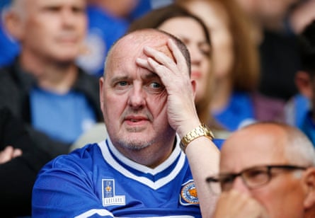 A Leicester City fan looks dismayed as his side are relegated despite beating West Ham 2-1 on the final day of the season