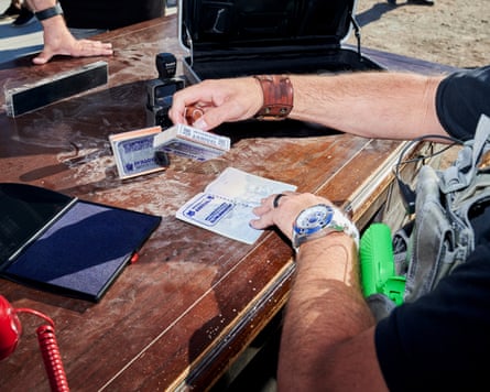 Man’s arms stamping passports during an event in the self-proclaimed micro-nation.