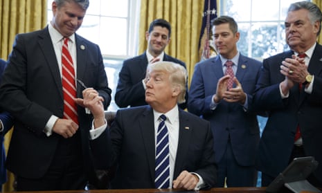 Donald Trump hands a pen to Representative Bill Huizenga after signing House Joint Resolution 41, which lifts rules obliging oil companies to disclose payments to foreign governments.