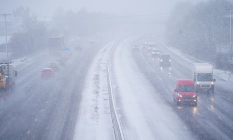 Cars driving through snow on the the M5 motorway near Taunton, Somerset.