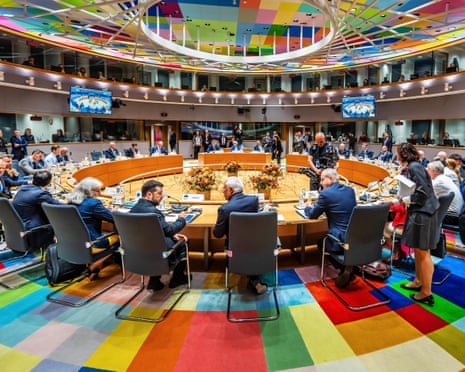 Zelenskyy and EU leaders sit around a circular table at the EU Summit