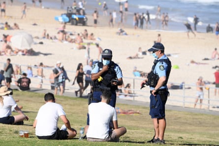 Hot weather in Sydney amid Covid-19 pandemic. Police speak with two men at Bondi beach, in Sydney, New South Wales, Australia, 11 September 2021