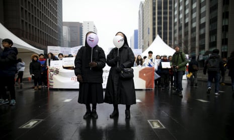 Nuns holding balloons prepare to march during a rally in central Seoul.