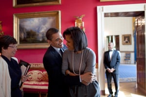 The president hugs First Lady Michelle Obama in the Red Room
