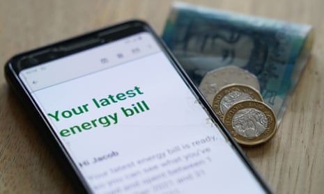 energy bill on smartphone next to some pound coins nd £5 notes