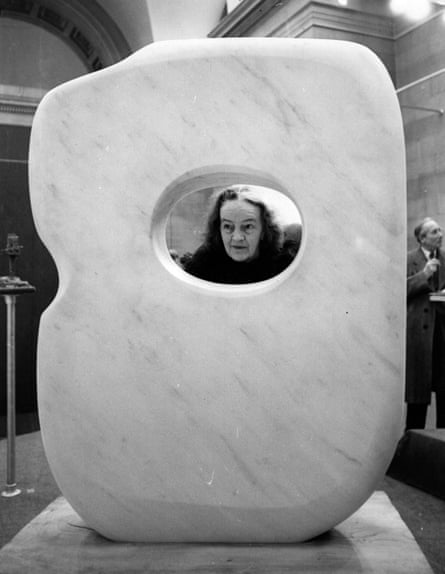 Hepworth peering through a hole in a large sculpture
