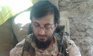 Dr Issam Abuanza with an automatic rifle in a photograph posted online.