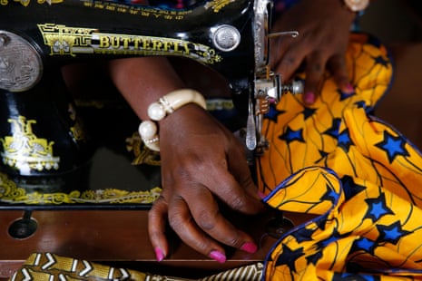 Chrystelle Oga using a sewing machine