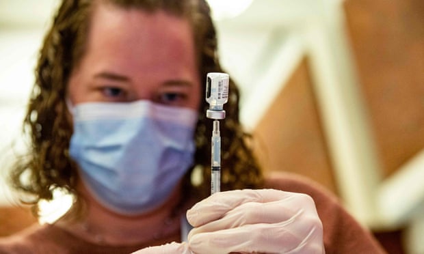 A medical worker prepares a Pfizer-BioNTech jab.