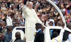 Pope Francis waves to the faithful as he arrives for a Papal mass in Nairobi in November 2015