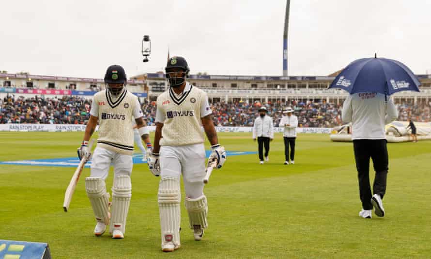 Rain stop play: India’s Virat Kohli and Hanuma Vihari walk off the field during a rain delay