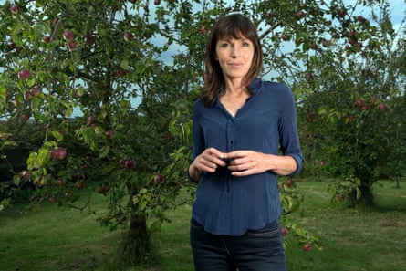 Rachel Cusk in front of an apple tree at her home in Norfolk, England.
