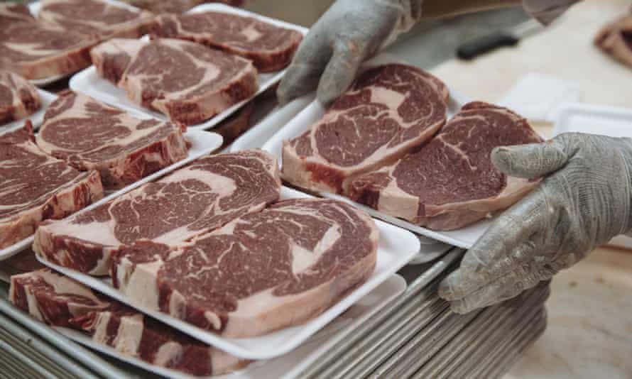 A worker stacks sliced beef steaks on a tray in a supermarket in New Jersey, US.