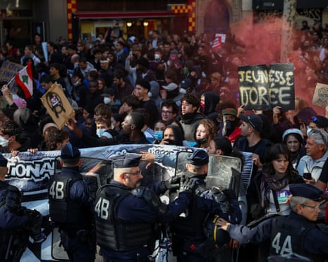 French CRS riot police stand in position at Place de la Bastille amid clashes with protesters during a demonstration by French high school and university students in Paris.