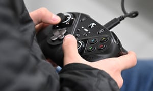 A visitor plays a video game with an Microsoft Xbox controller