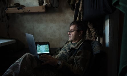 Yaroslav Pilunskiy looks at a screen in a dark room