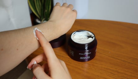 The tester applying Rituals body moisturiser to her arm