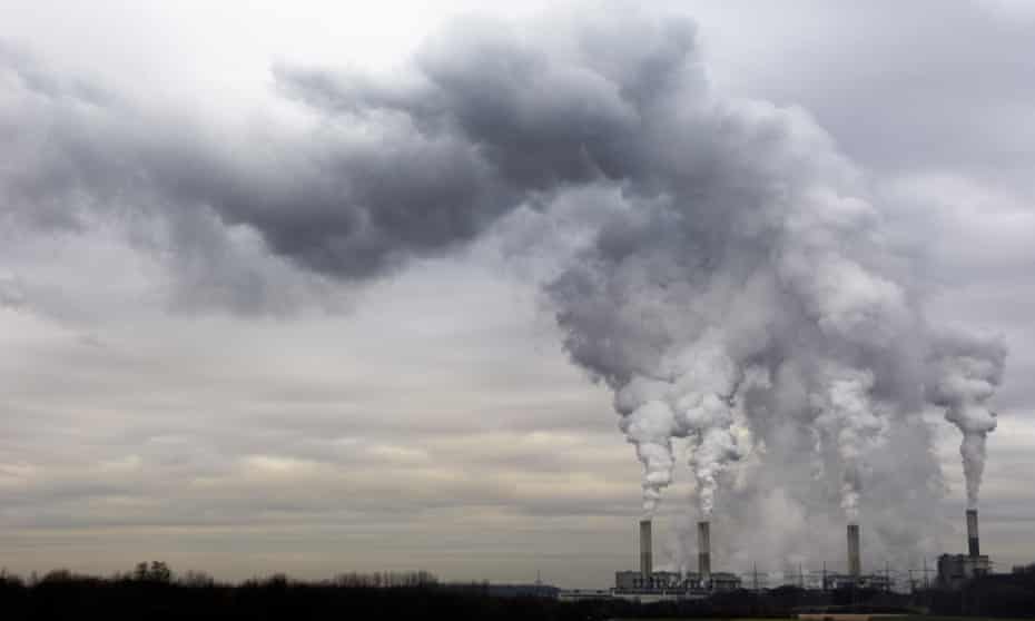 Coal burning power plant with pollution on a cloudy day.