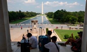 Tourists shelter from the sun at the Lincoln Memorial on the National Mall in Washington, DC.