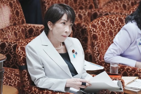 Sanae Takaichi listens to a question about the situation in the Middle East during a budget committee session.