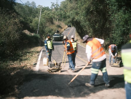 Road workers repair a section of highway