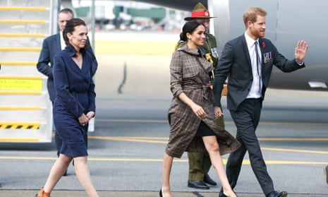 Prince Harry and Meghan, the Duke and Duchess of Sussex, walk with New Zealand Prime Minister Jacinda Ardern shortly after they arrive at the Wellington International Airport in October 2018.