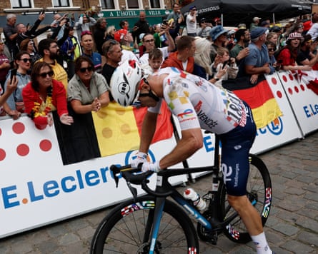 Mattéo Vercher of Total Energies gets back on his bike after colliding with Cofidis’s Benjamin Thomas.