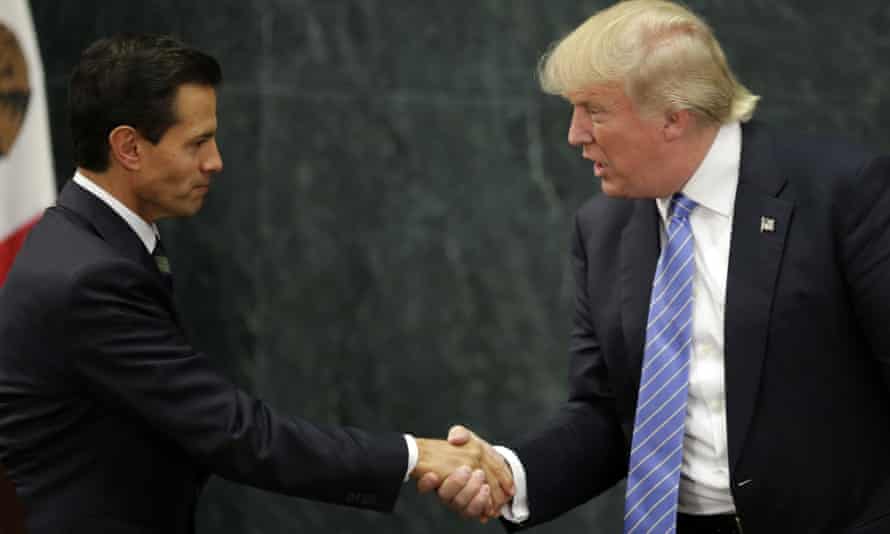 (FILES) This file photo taken on August 31, 2016 shows Mexican President Enrique Pena Nieto (L) and US presidential candidate Donald Trump shaking hands after a meeting in Mexico City. Donald Trump said on November 9, 2016 he would bind the nation’s deep wounds and be a president “for all Americans,” as he praised his defeated rival Hillary Clinton for her years of public service. / AFP PHOTO / YURI CORTEZYURI CORTEZ/AFP/Getty Images