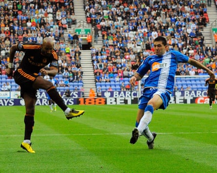 Chelsea’s Nicolas Anelka (left) scores against Wigan in August 2010.