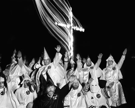 Black and white image of a Ku Klux Klan “cross lighting” ceremony in Arkansas, US, 1990
