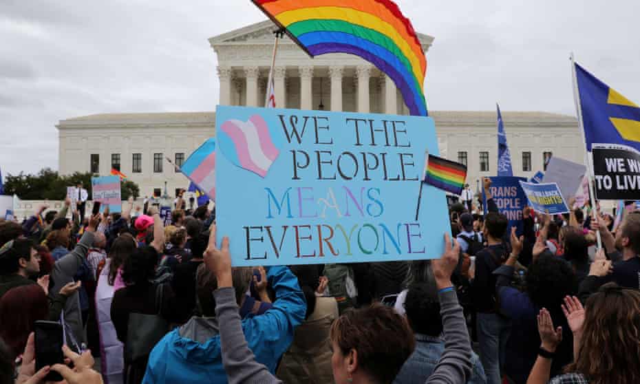 Activists and supporters hold a rally outside the US supreme court as it hears arguments in a major LGBTQ+ rights case.