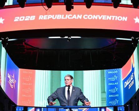 A large screen display shows Scott Bessent speaking at the Republican midterm convention in Dallas, Texas,