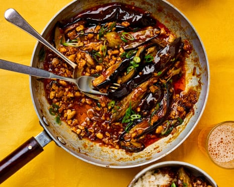 Meera Sodha's 'fish fragrant' aubergines in a skillet with rice bowls and a beer.
