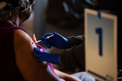 A woman is given a vaccine in Louisville, Kentucky, on 12 February. Despite some progress access to the Covid vaccines is disproportionately low for Latino and Black Americans.