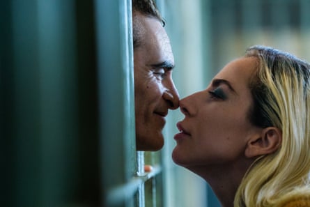 Joaquin Phoenix and Lady Gaga touch noses.