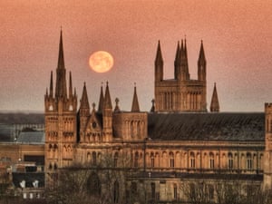 The moon appears behind Peterborough Cathedral in Cambridgeshire