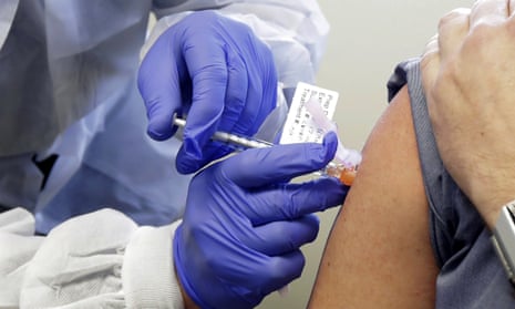 A man receives a shot as part of a first-stage study for a potential coronavirus vaccine, Seattle.