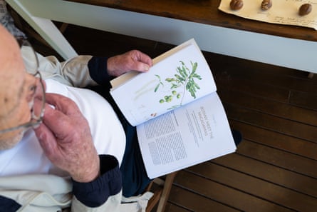 Top down shot of Ian McConachie holding a book open
