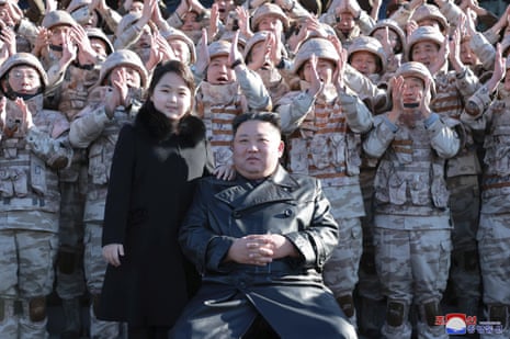 North Korean leader Kim Jong-un poses with his daughter and soldiers in an image released on Sunday.